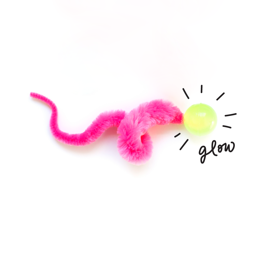 Dezi & Roo - Wiggly Glow ball - pink fuzzy tail toy with a green glow ball on a white background