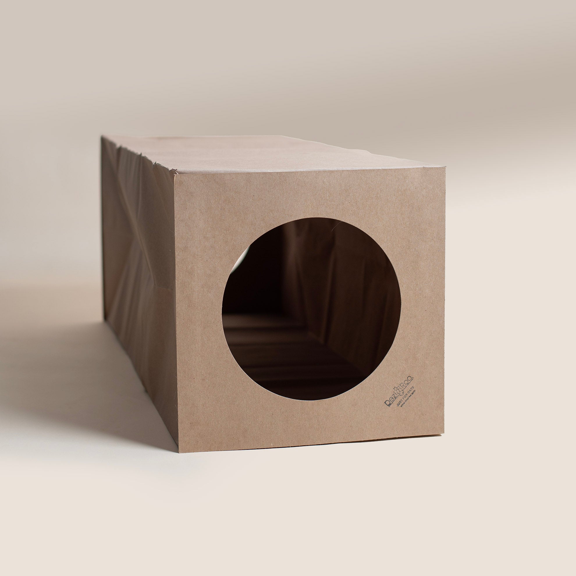 Dezi & Roo - brown cardboard cat tunnel with a circular hole on both ends